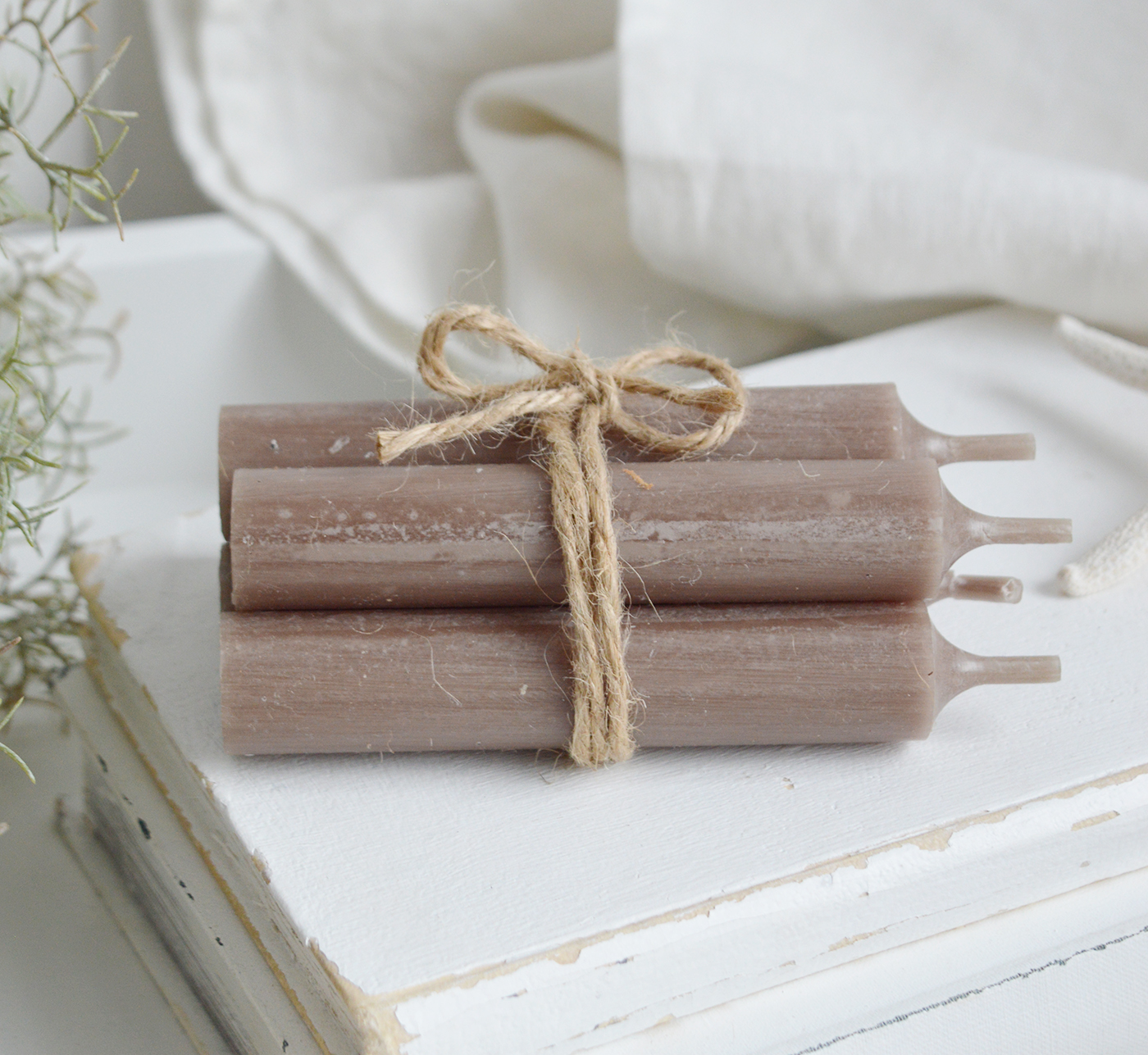 A taupe bundle of candles for contrastion styling in neutral homes