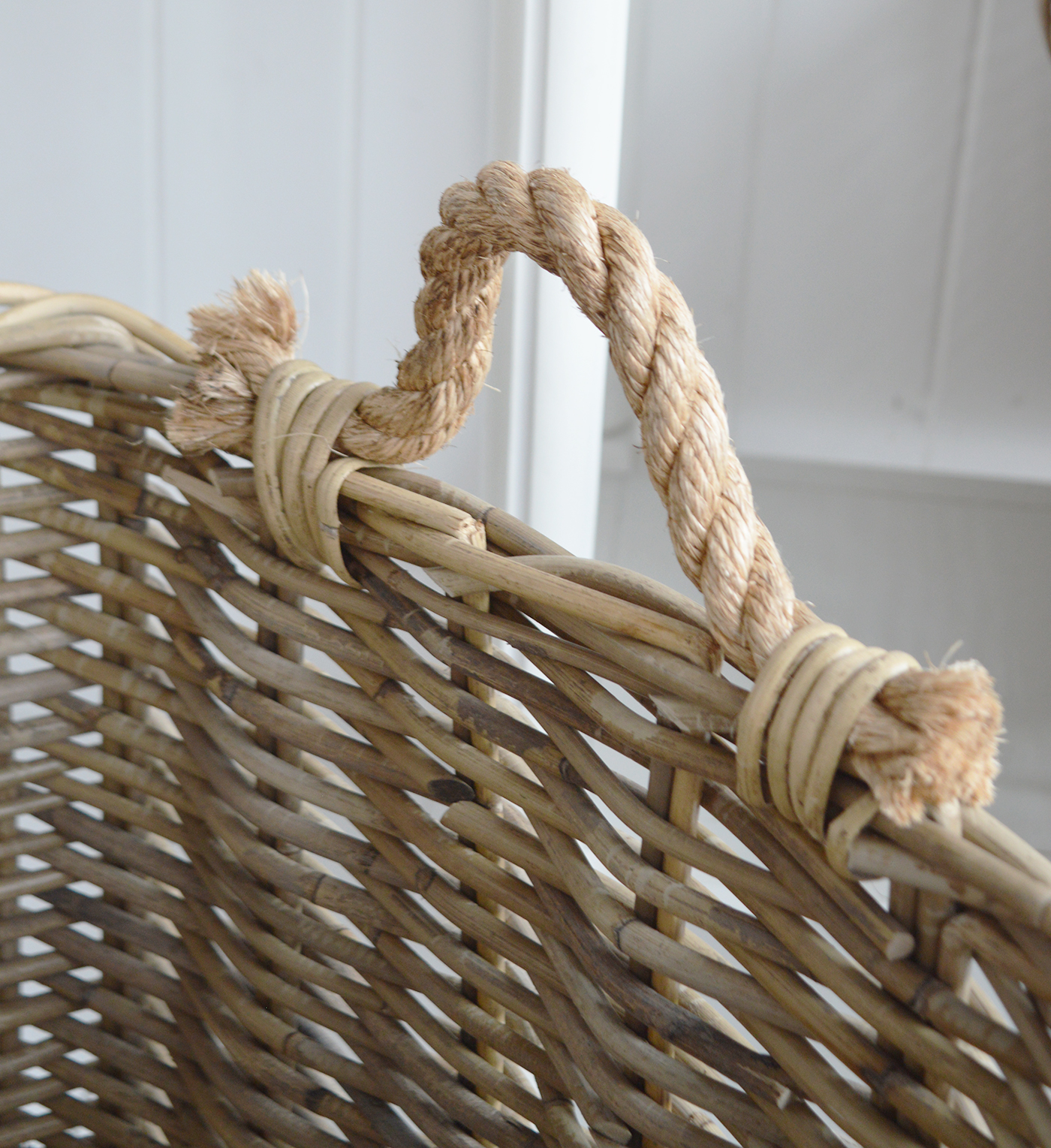 Use this natural rattan basket to organise cushions, throws and everyday living-room essentials.