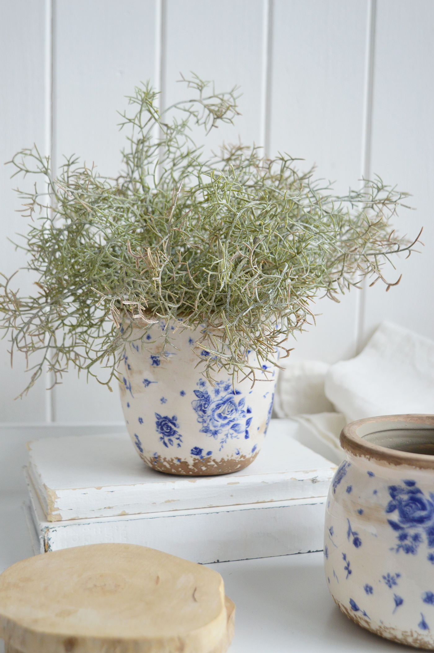 Rustic Vintage Blue Rose pottery vase standing on a weathered wooden shelf in soft natural light