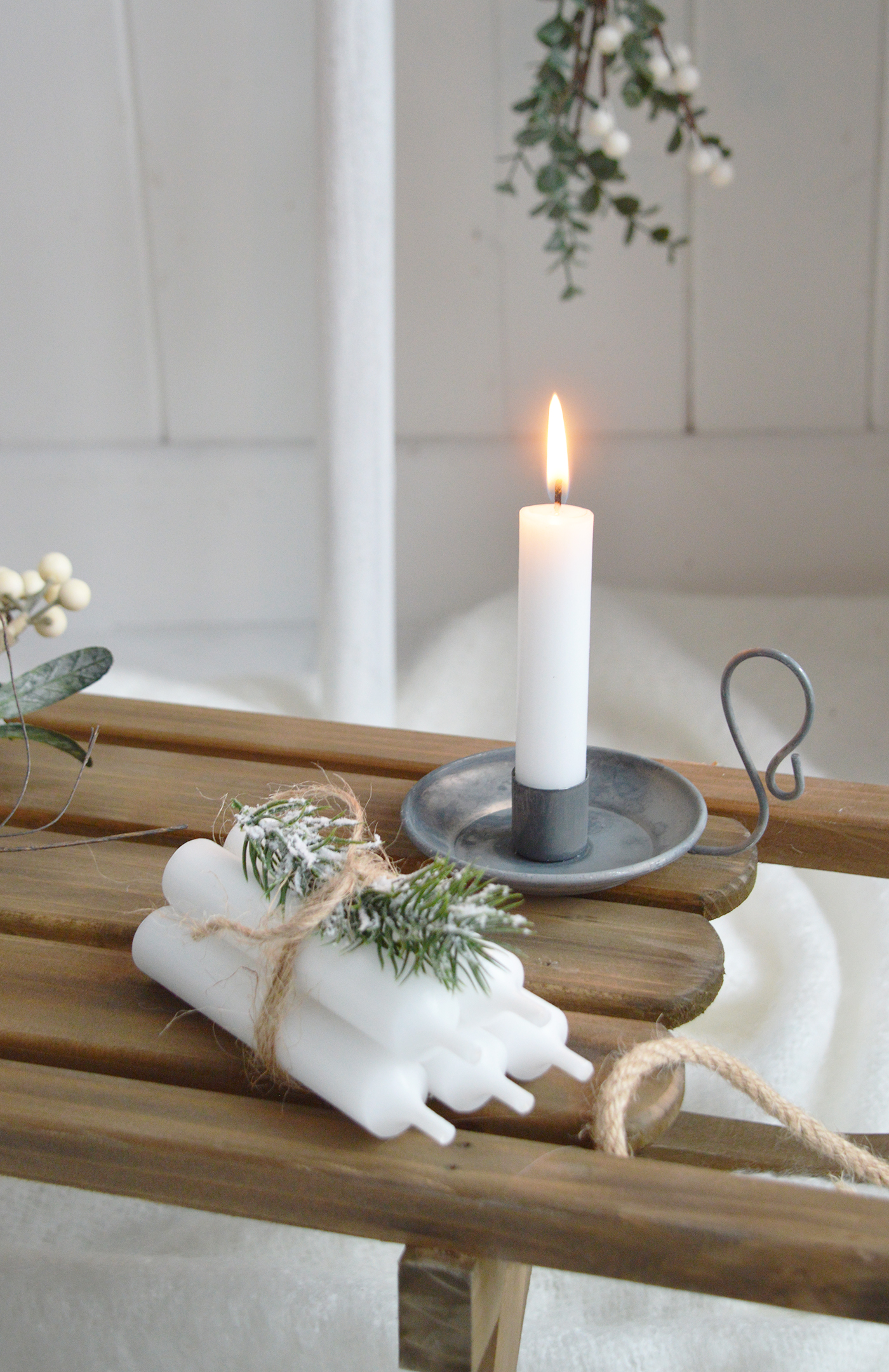 A Christmas styles candle - chamber stick with white candle and bundle