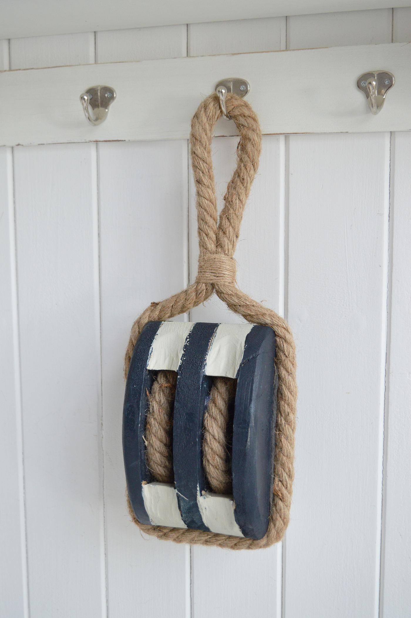 Decorative wooden pulley with rope, perfect for beach house and coastal interiors.