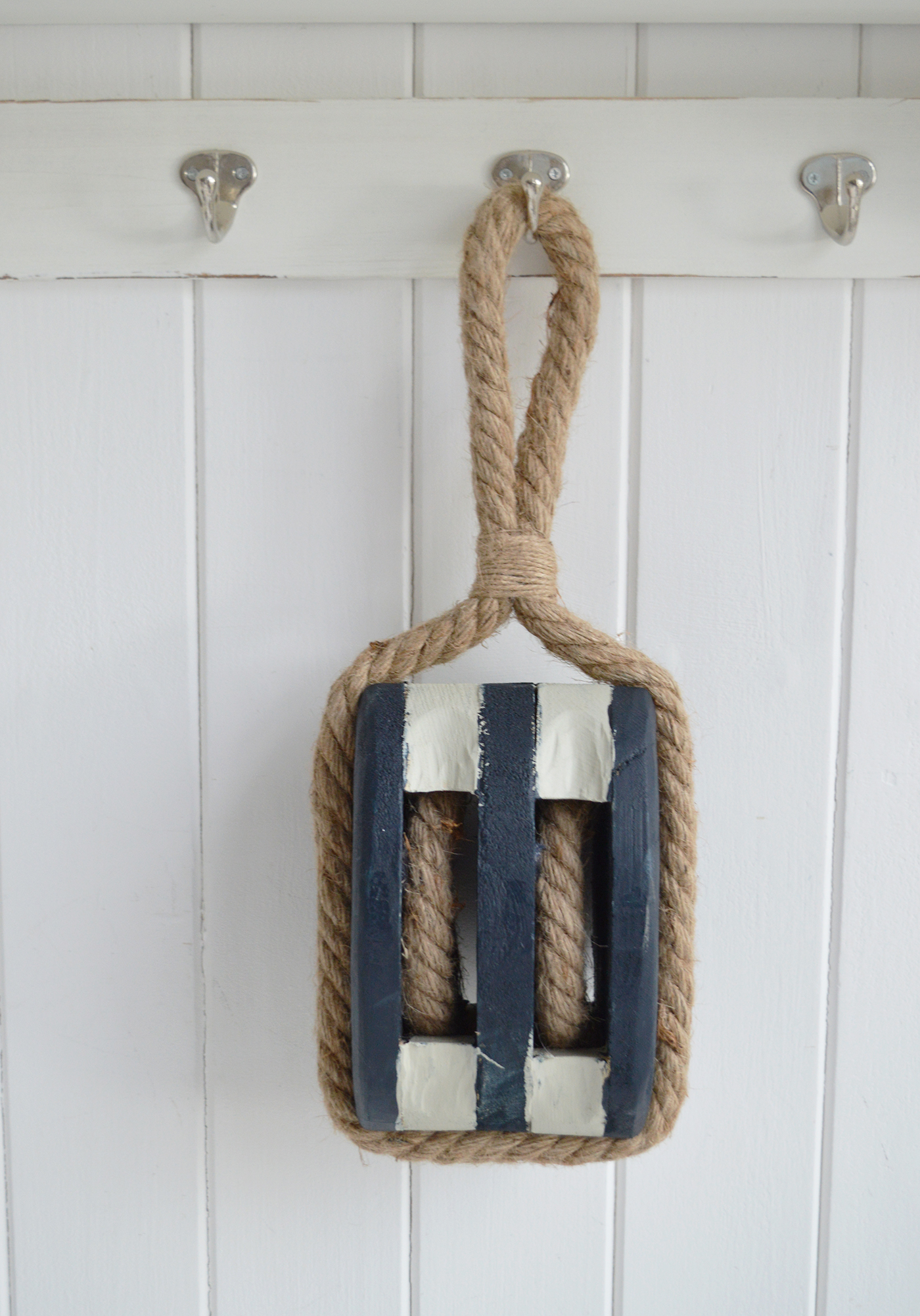 Nautical pulley block accessory enhancing ocean-inspired coastal interiors style.