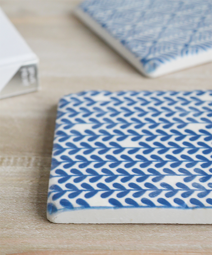 A set of blue and white ceramic coasters The White Lighthouse Home