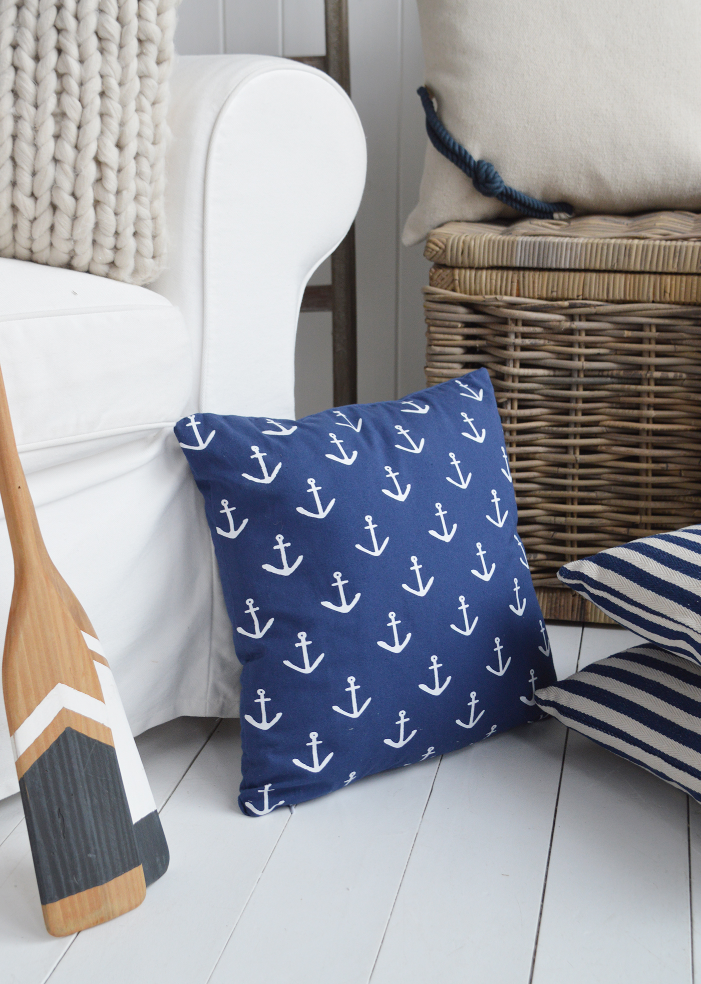 The Navy and white anchor coastal cushion, styled with paddle oars and the Harrison stripe cushion