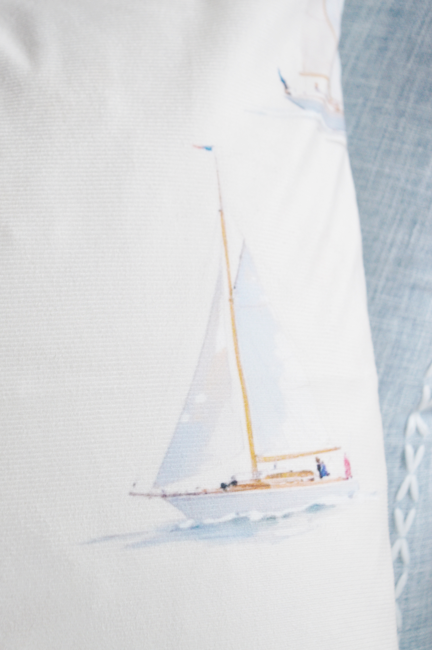 Sailboat design cushion cover styled among soft coastal textures