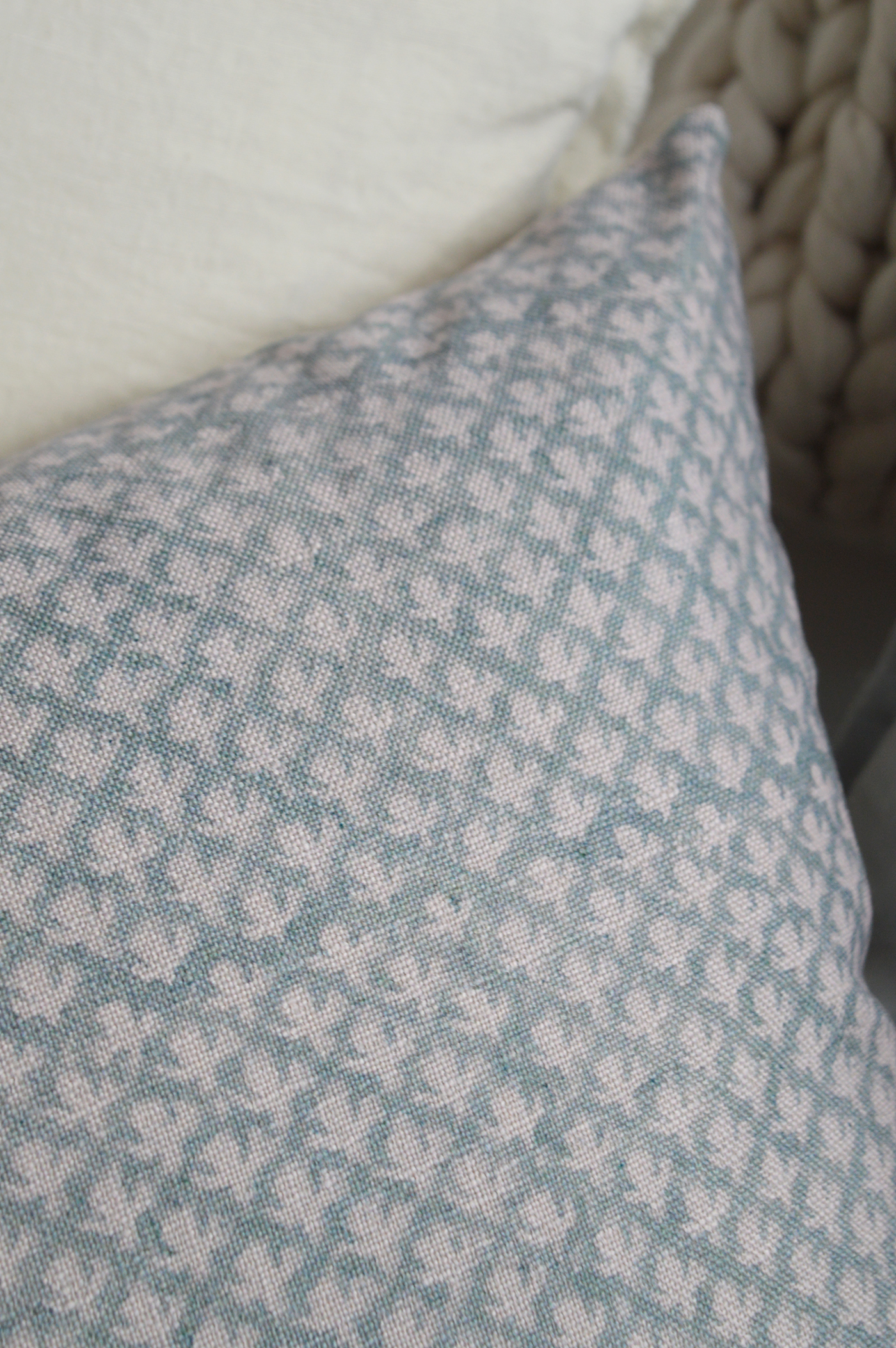 Hamptons style luxury cushion with subtle floral pattern on textured fabric