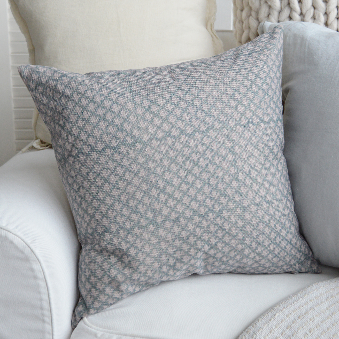 The Nantucket Luxury coastal cushion in blue and white on a white Hamptons-style armchair