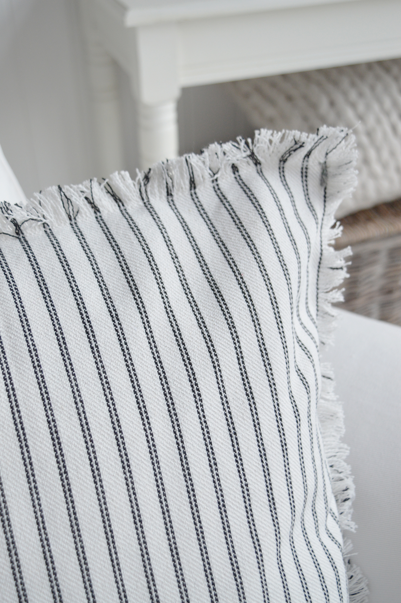 Soft striped cushion cover enhancing a neutral seaside-inspired room