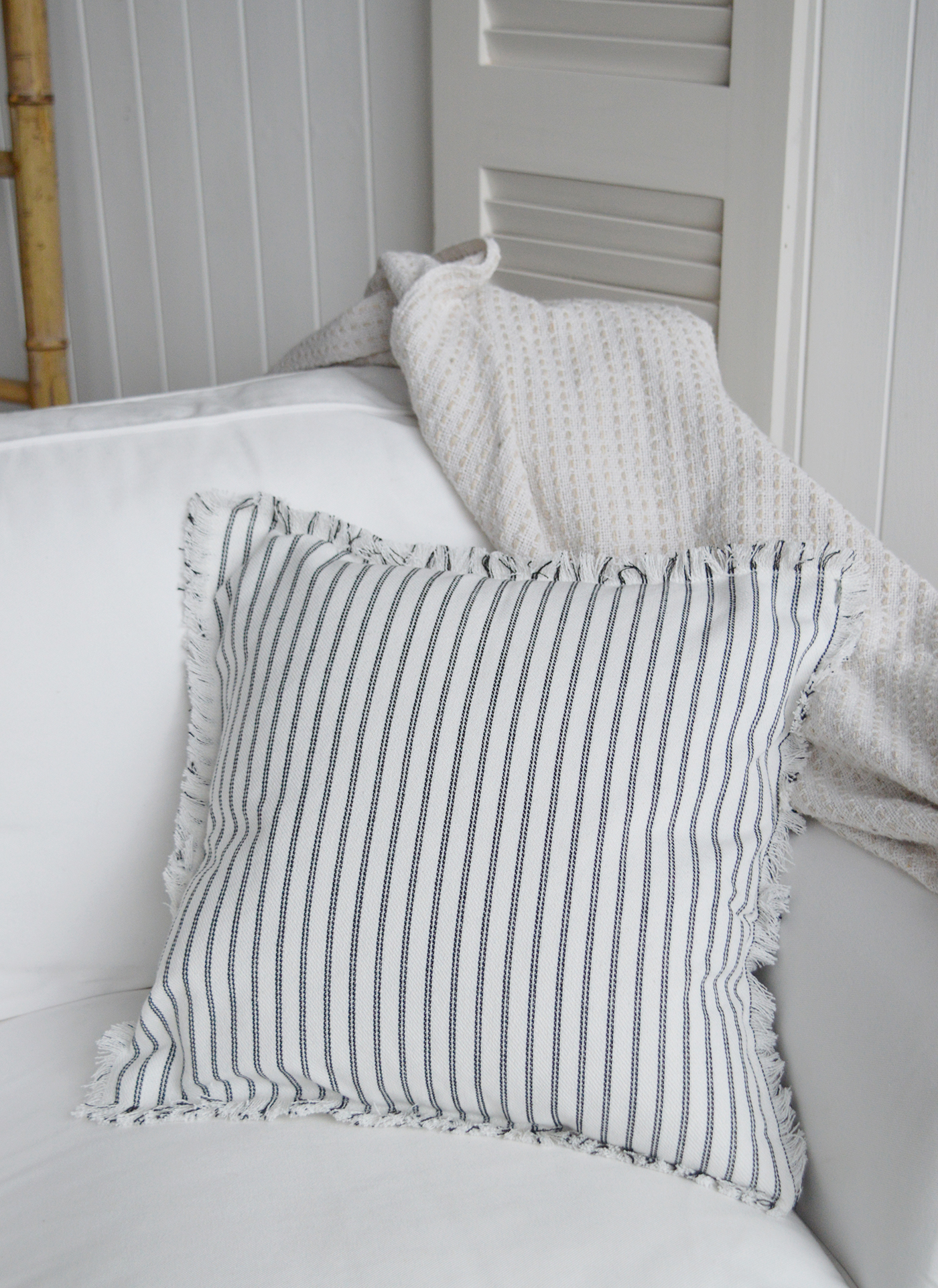Quincy cushion cover with charcoal stripes styled in a light coastal living room.
