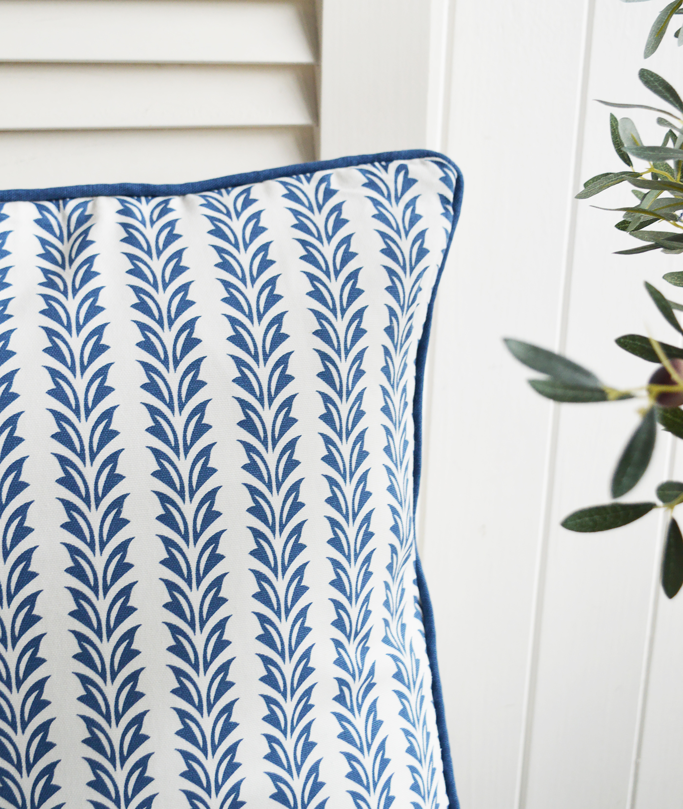 In this Cape Cod-style interior, blue and white cushions offer a timeless palette reminiscent of sea spray and sky.