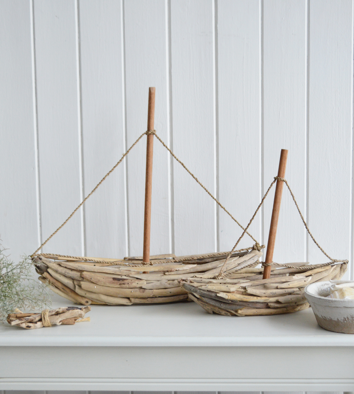 Handmade decorative driftwood yacht with natural wooden mast and rope sails, perfect for coastal décor and nautical themed interiors