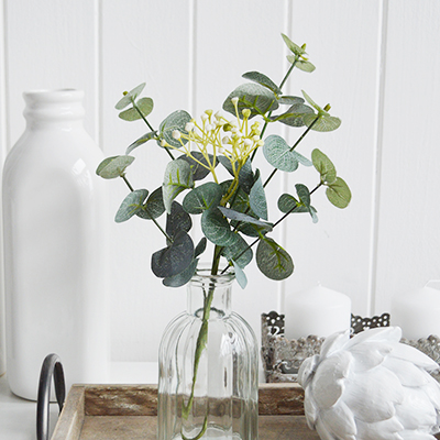 Artificial Eucalyptus sprig with white flowers. Simple greenery to add to New England styled interiors for coastal, country, city and farmhouse homes