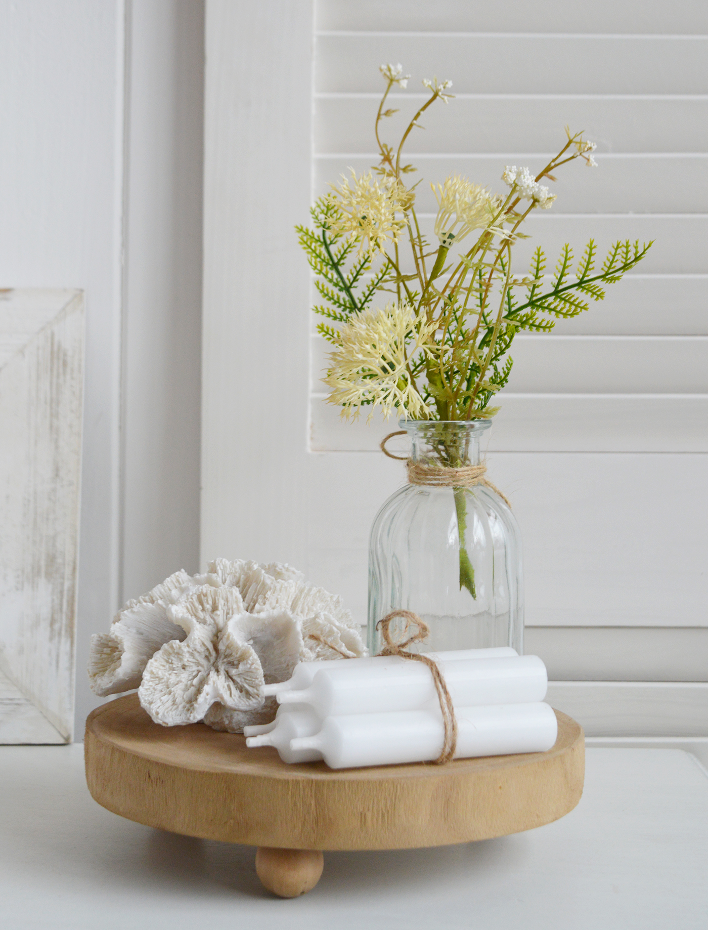 A coastal styled tray with the mini thistle and fern sprigs with faux coral