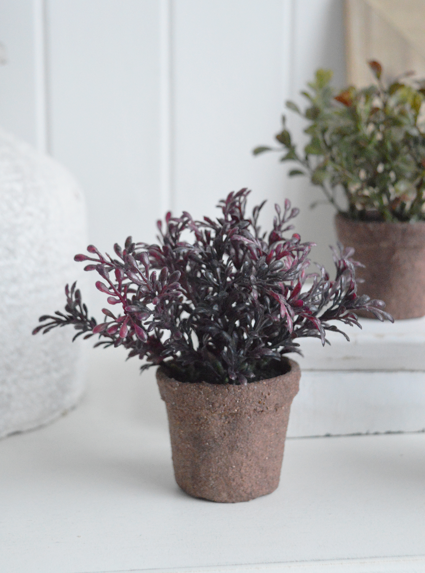 With muted green tones and aged rustic pots, this faux succulent set complements white furniture, coastal neutrals and modern country interiors beautifully.