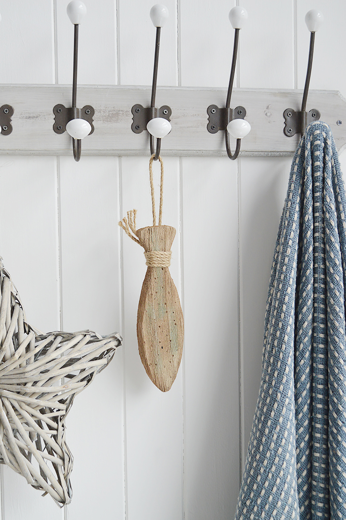 A hanging distressed wooden fish for coastal interiors and homes