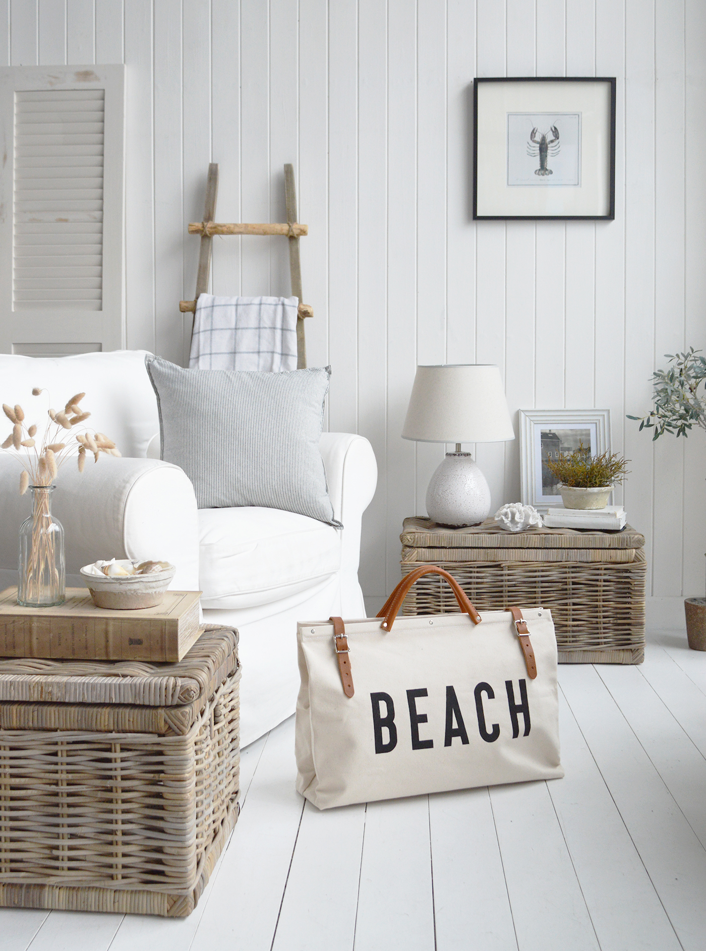 The White Sanford ceramic lamp in a coasta beach house inspired living room filled with furniture pieces made from natural materials