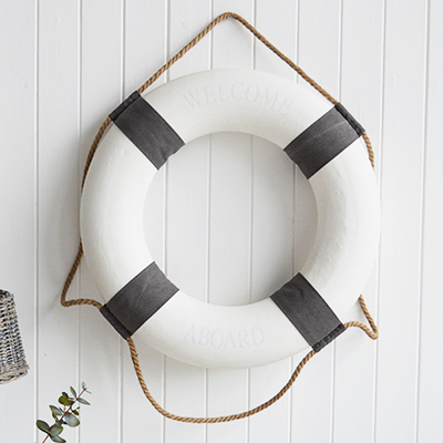 A white and grey vintage style lifebuoy.The complementing grey and white along with the natural rope and subtle Welcome Aboard offer a touch of Coastal Chic decor to your room.