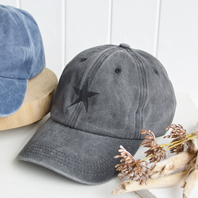 The Charcoal Grey Star Cap delivers understated depth and modern coastal edge, a timeless shade that pairs seamlessly with neutral wardrobes.