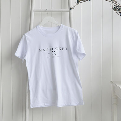 Soft white cotton t-shirts blending New England heritage with an effortless, relaxed coastal lifestyle aesthetic.