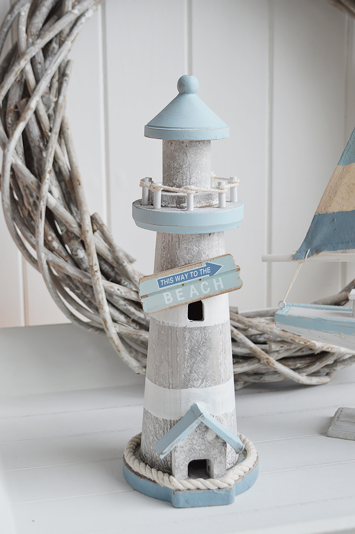 Decorative wooden lighthouse in greys and blues with coastal emblems for Beach house furniture