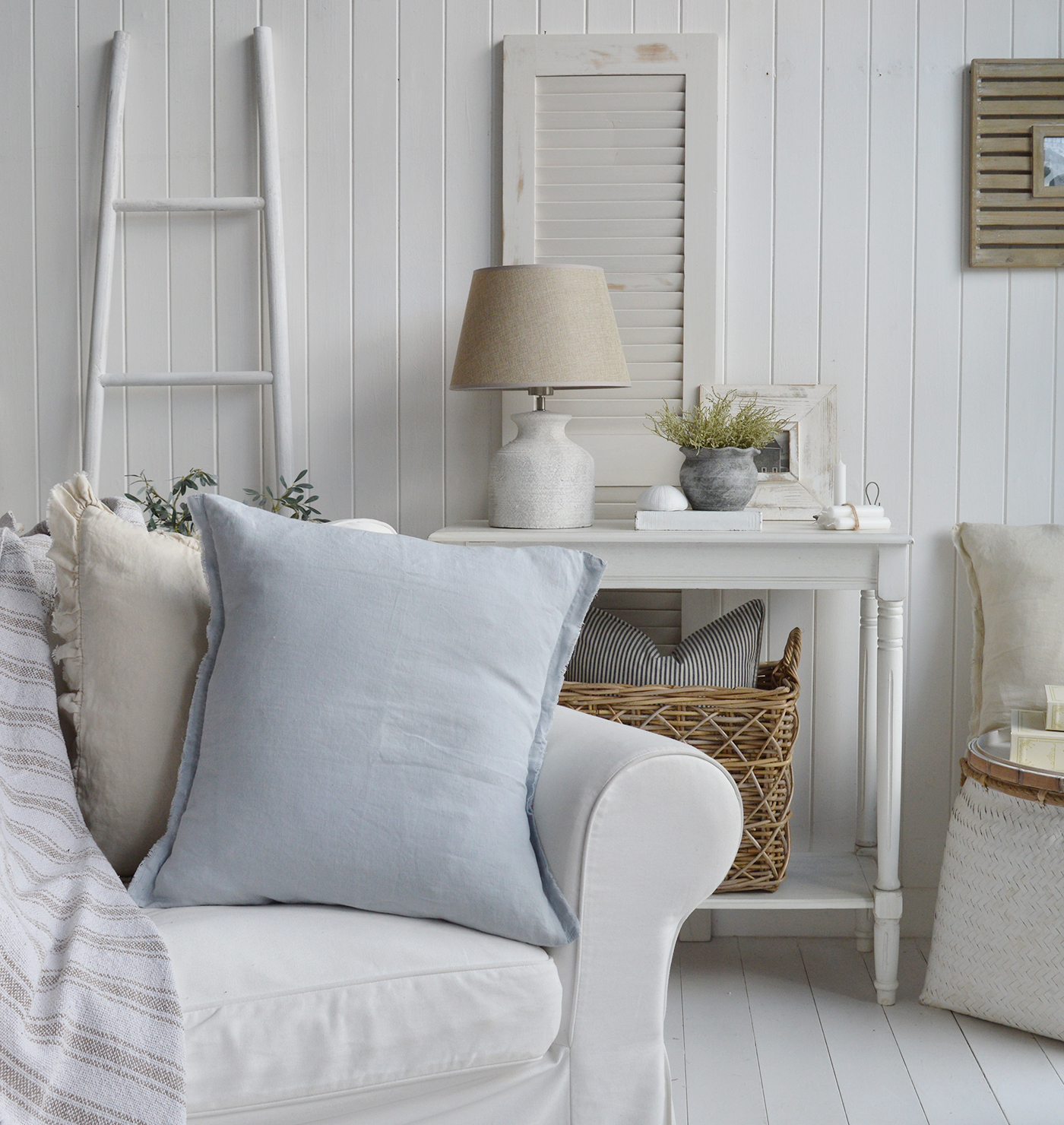  A coastal inspired living room, New England style with white furniture, Hamilton linen cushions, and accessories