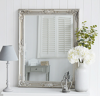 A mirror on your table is a must, we love the look of a large mirror, in this case, a silver mirror, simply resting on the table.