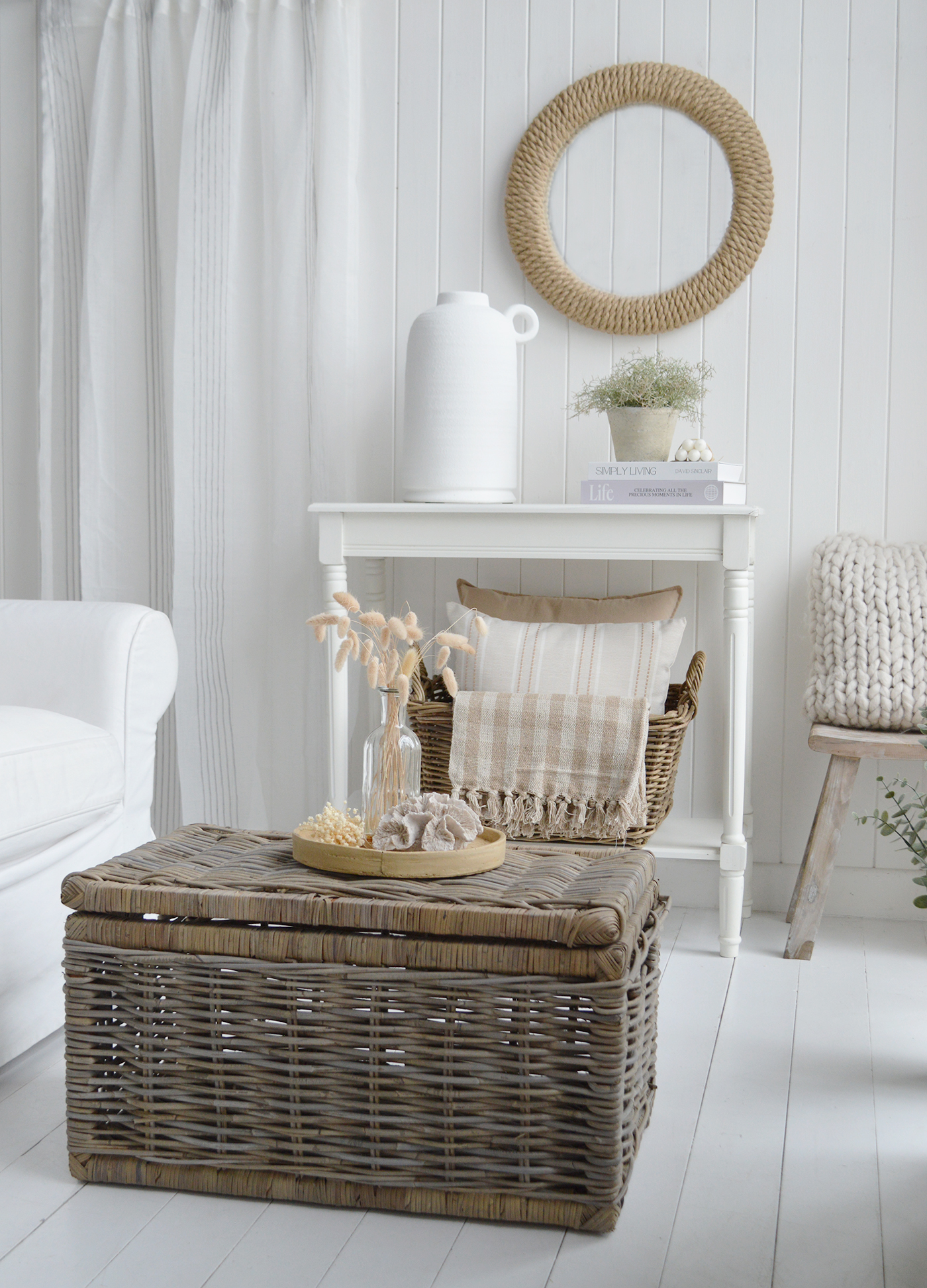 Create a calming coastal living room with layered neutral textures, natural rattan furniture and timeless New England styling. Bring the charm of Hamptons interiors into your home with white furniture, natural fibres and warm sandy tones.