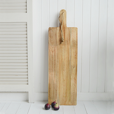 Leaning against the wall when not in use, the beautifully crafted Grafton  wooden paddleboard doubles as both a decorative accent and a functional serving piece