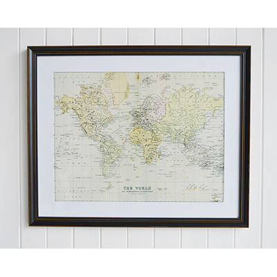 A framed print of The World on Mercators Projection by J. Barthholomew P.R.G.S in a vintaged black frame with a thick white mount.