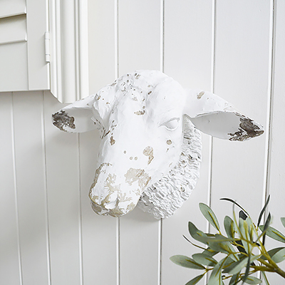 White cast of a distressed sheep head to hang on wall