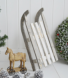 A gorgeous decorative wooden white and grey rustic sleigh for elegant Christmas decorations from The White Lighthouse Furniture in New England , Country Coastal and City home interiors and furniture