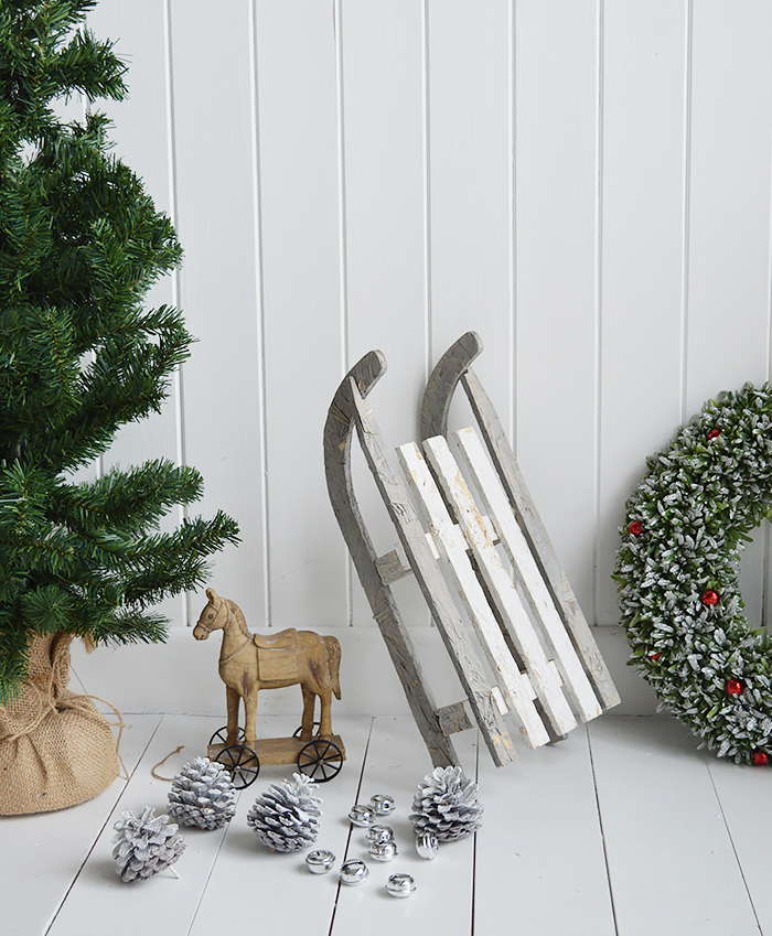 A gorgeous decorative wooden white and grey rustic sleigh for elegant Christmas decorations from The White Lighthouse Furniture in New England , Country Coastal and City home interiors and furniture