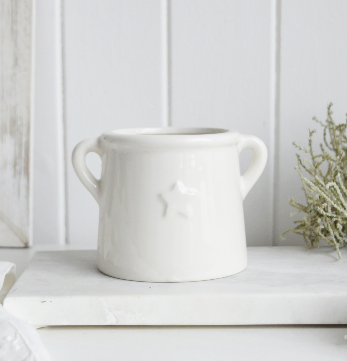 White ceramic star rangefor New England styling and white interiors. A small plate, candle holder and pot for Coastal, modern farmhouse furniture and home decor