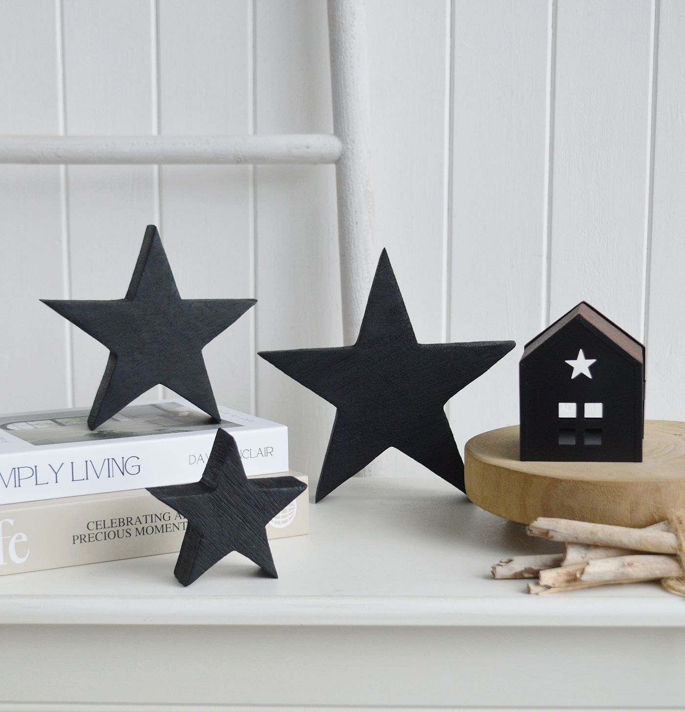 The sculptural shape of these wooden black stars adds depth and contrast to bright New England and modern coastal interiors.