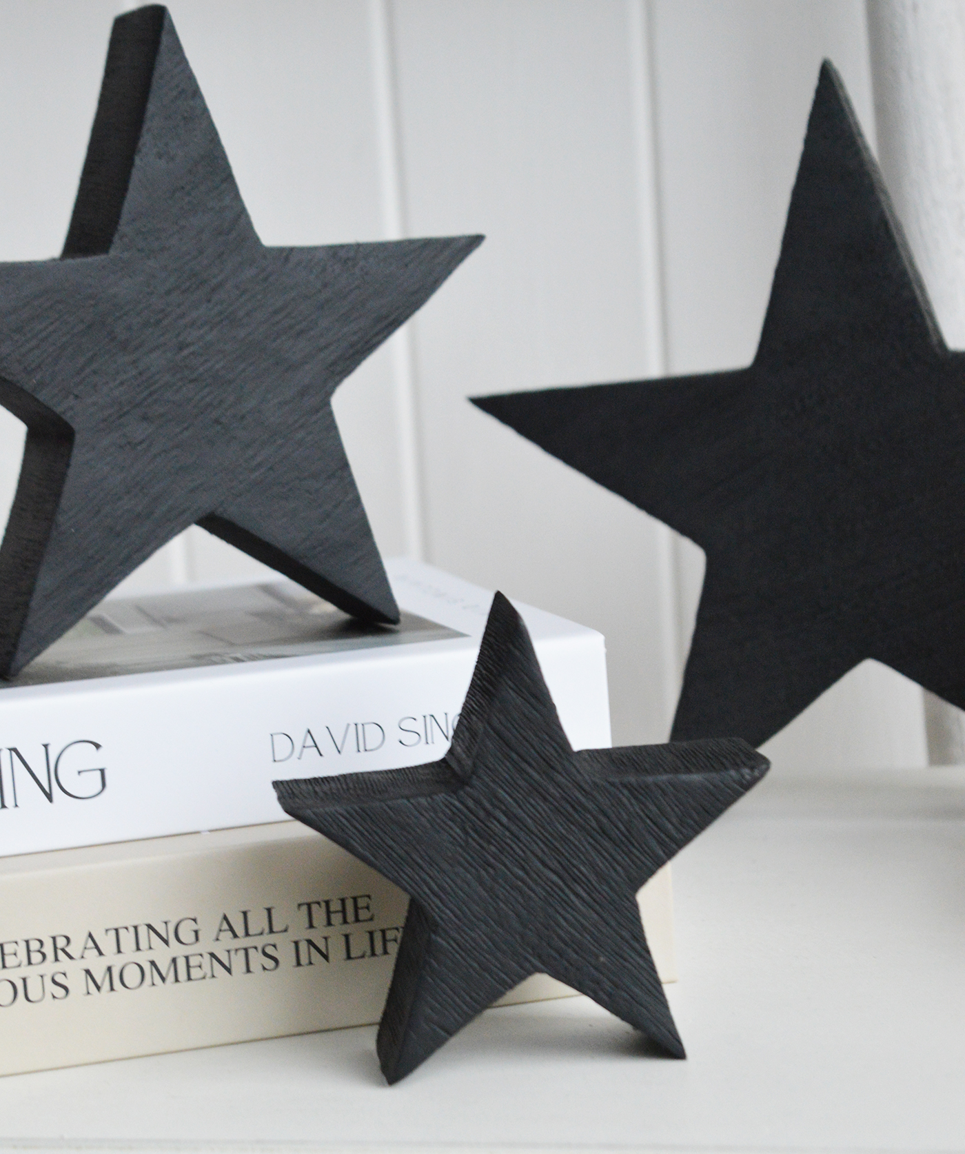 Perfect for shelf styling, these wooden black stars complement natural textures often found in coastal interiors.