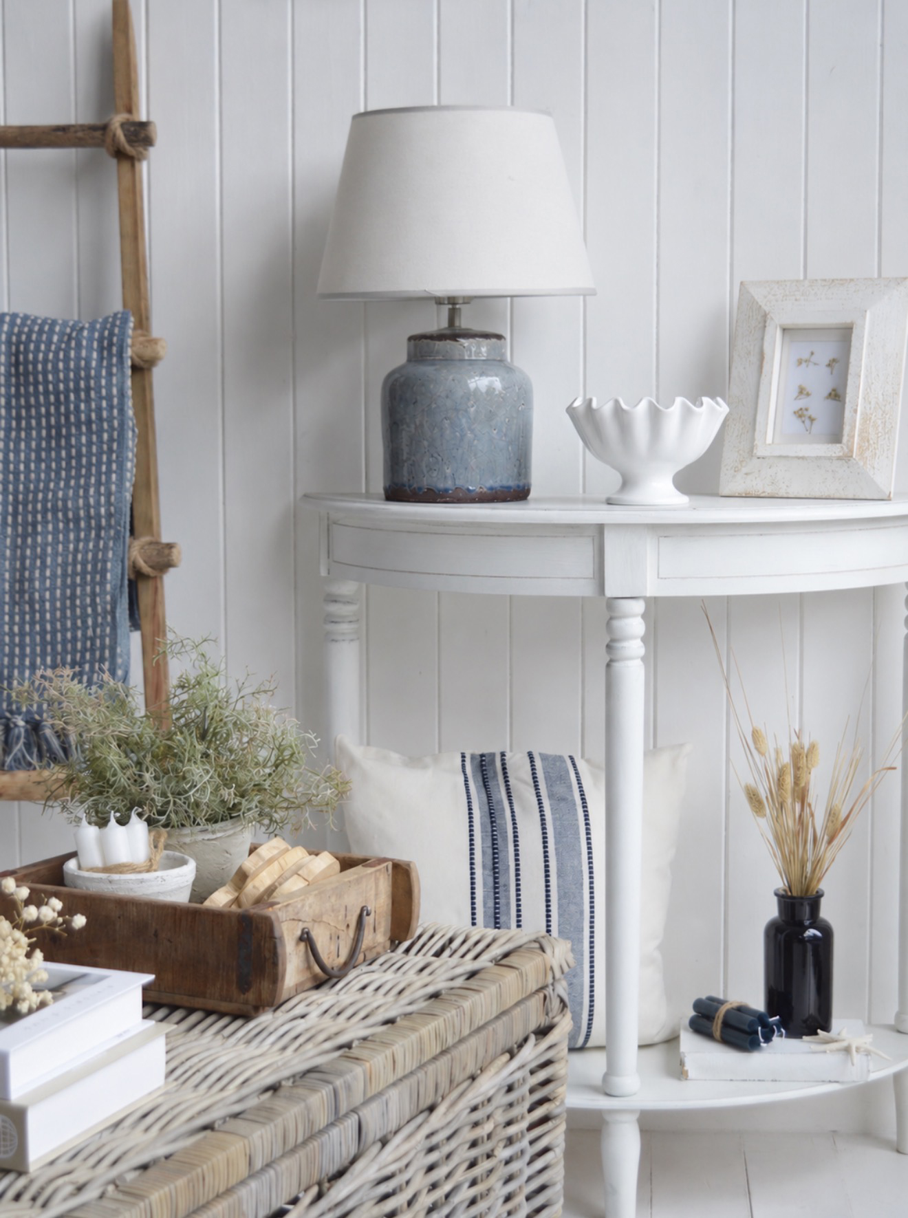 Bring warmth to New England interiors with a wooden storage box styled with complementary cottage home accessories.