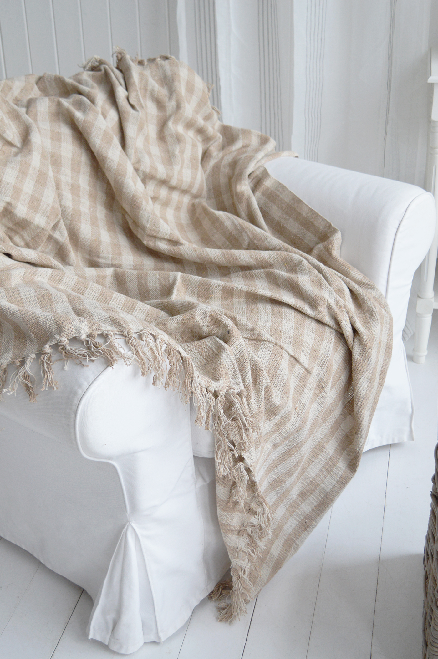 Featuring a soft sand and ivory check, the Stowe Sand Check Throw complements coastal home décor with its natural tones and classic woven design.