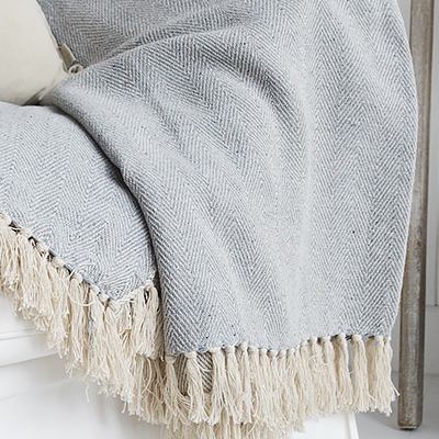 Stowe throws in blues, greys and natural coloures  for interiors in New England styles modern farmhouse, country, coastal and city homes from The White Lighthouse. Furniture and home interiors UK - Pale Grey Herringbone Throw