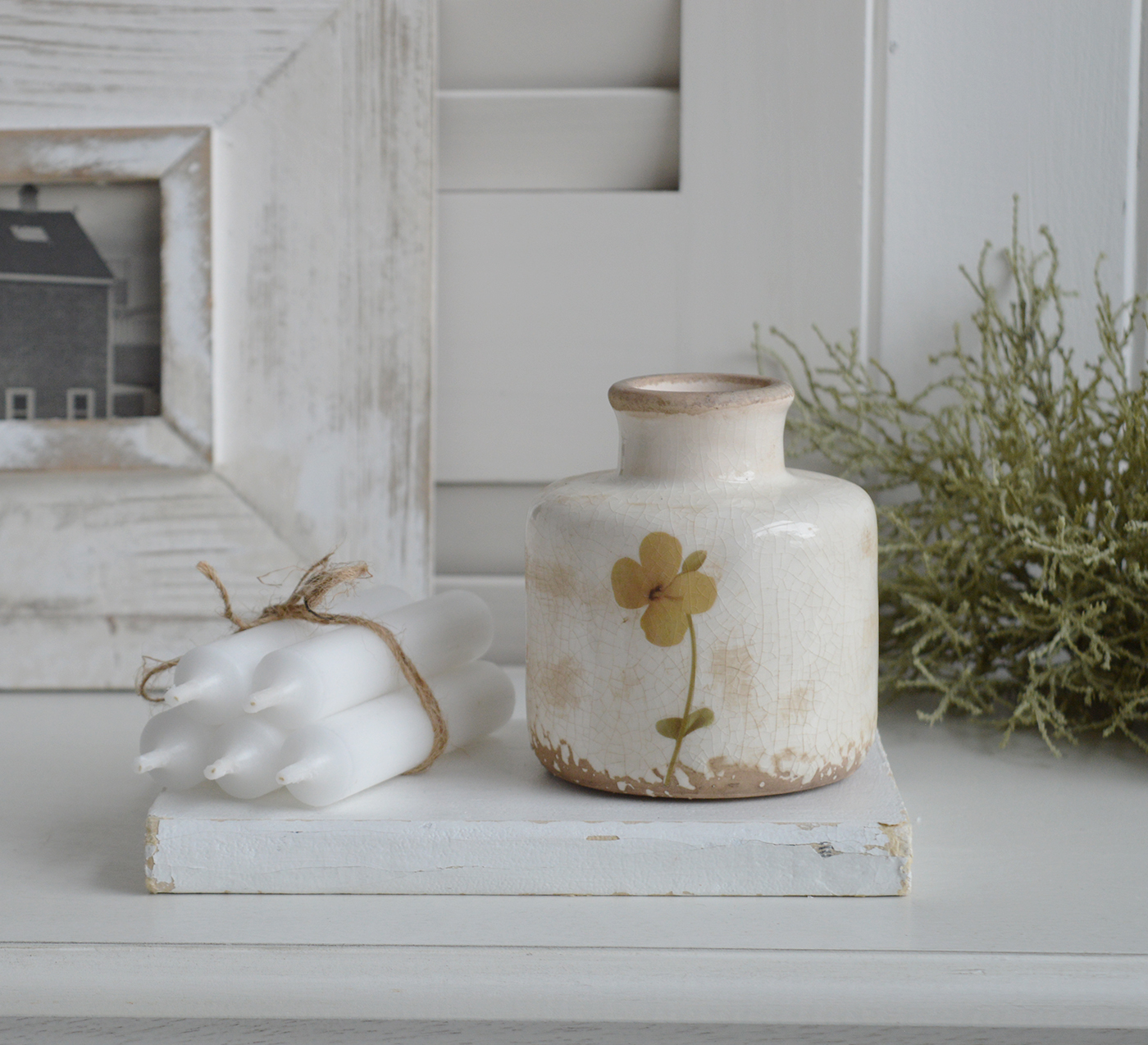 Mable ceramic vase with crackle glaze and floral design on wooden table