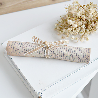 Neutral home decor styling piece for layered coffee table displays. Vintage script paper scroll styled with ceramics and dried florals in neutral interiors.