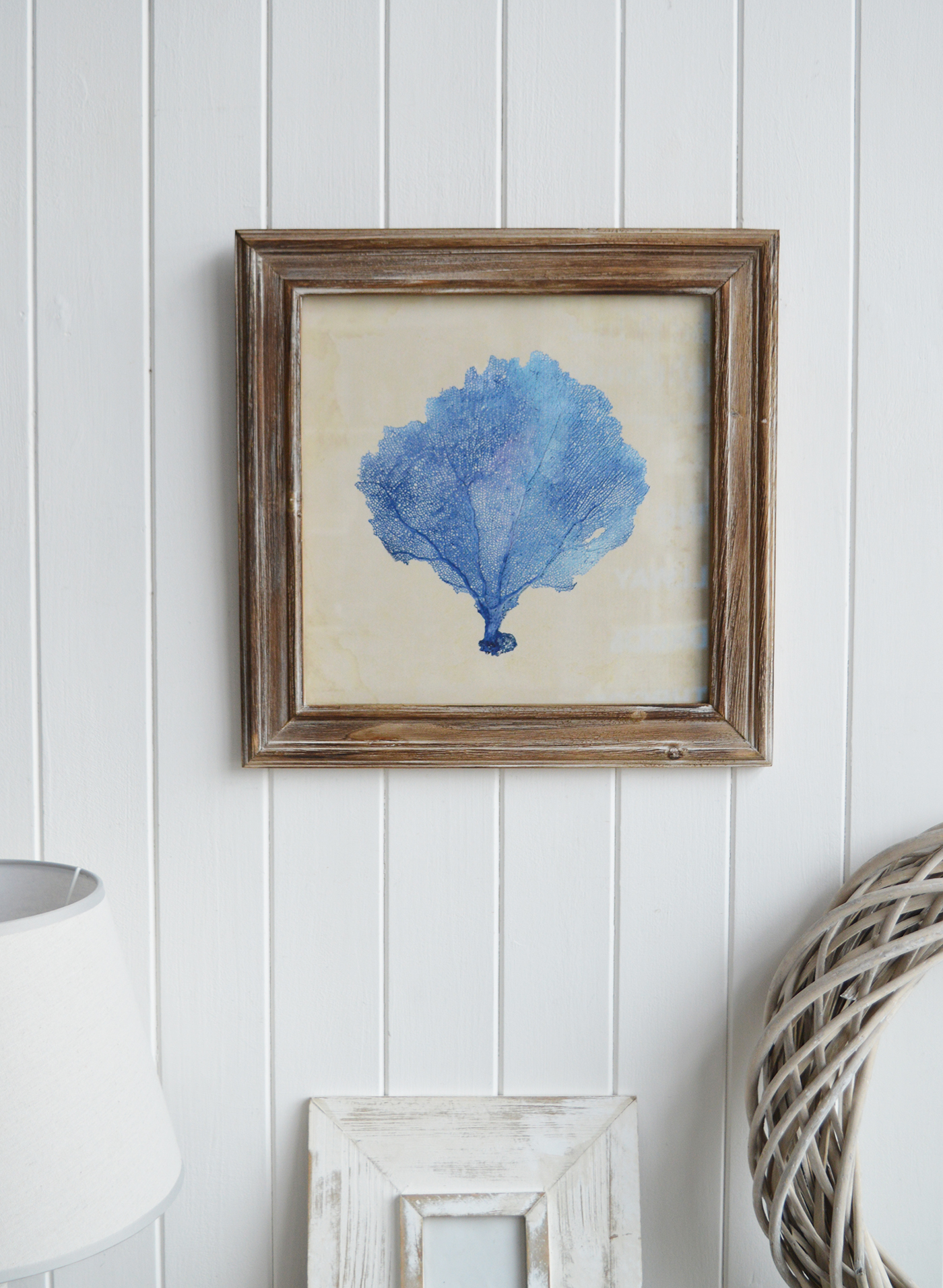 The aged blue coral print showcases a delicate, faded illustration, evoking a vintage coastal charm.