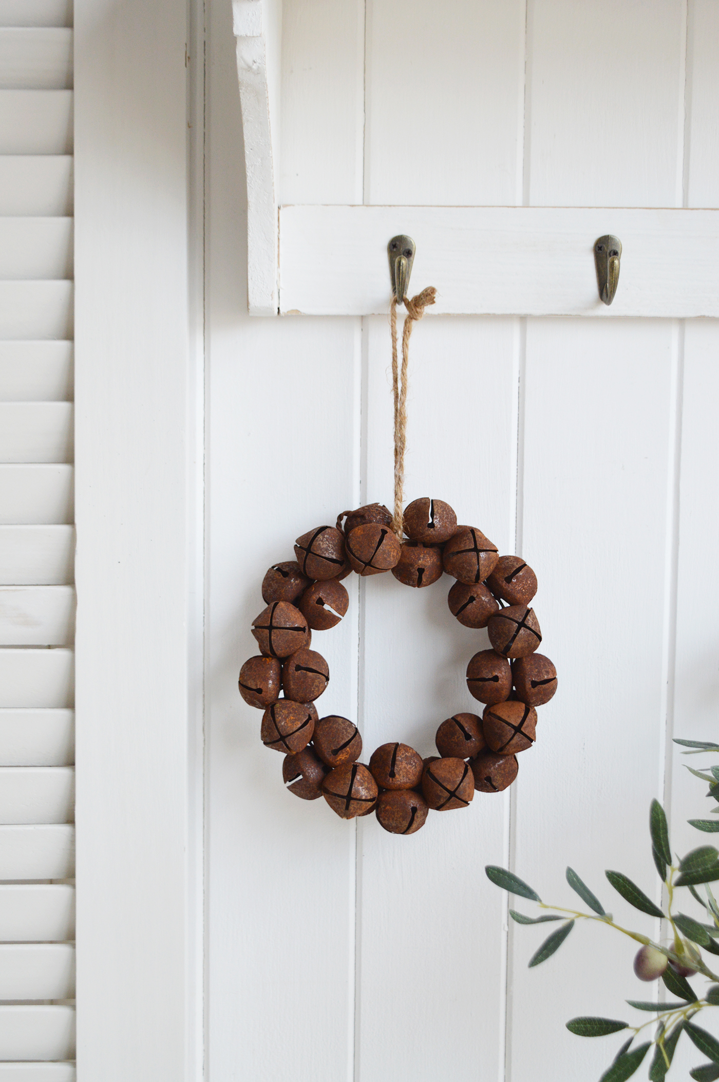 A rusty bell hanging wreath.This is an absolutely beautiful decoration in such a timeless style that will last for many years to comeHang on a peg or door handle for traditional New England farm house decor