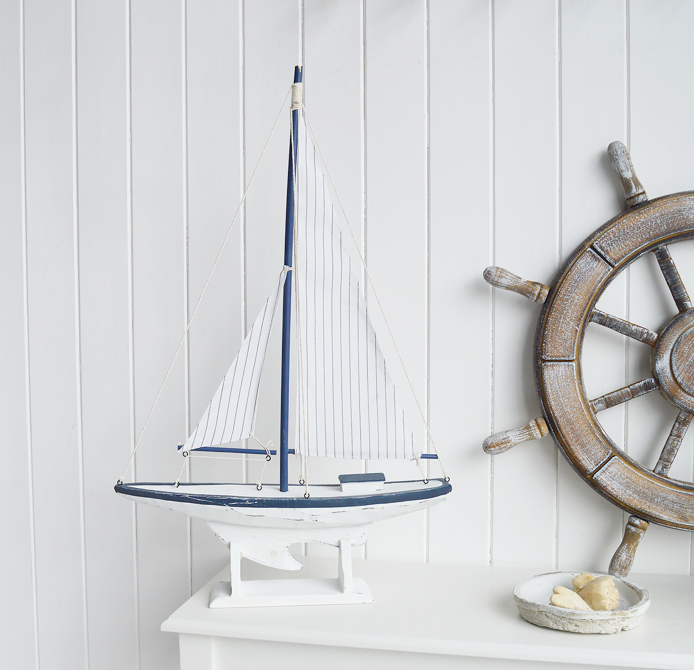 White Furniture and accessories for the home. A decorative white and blue yacht. Coastal Nautical Interior design Accessories for New England style homes and interiors