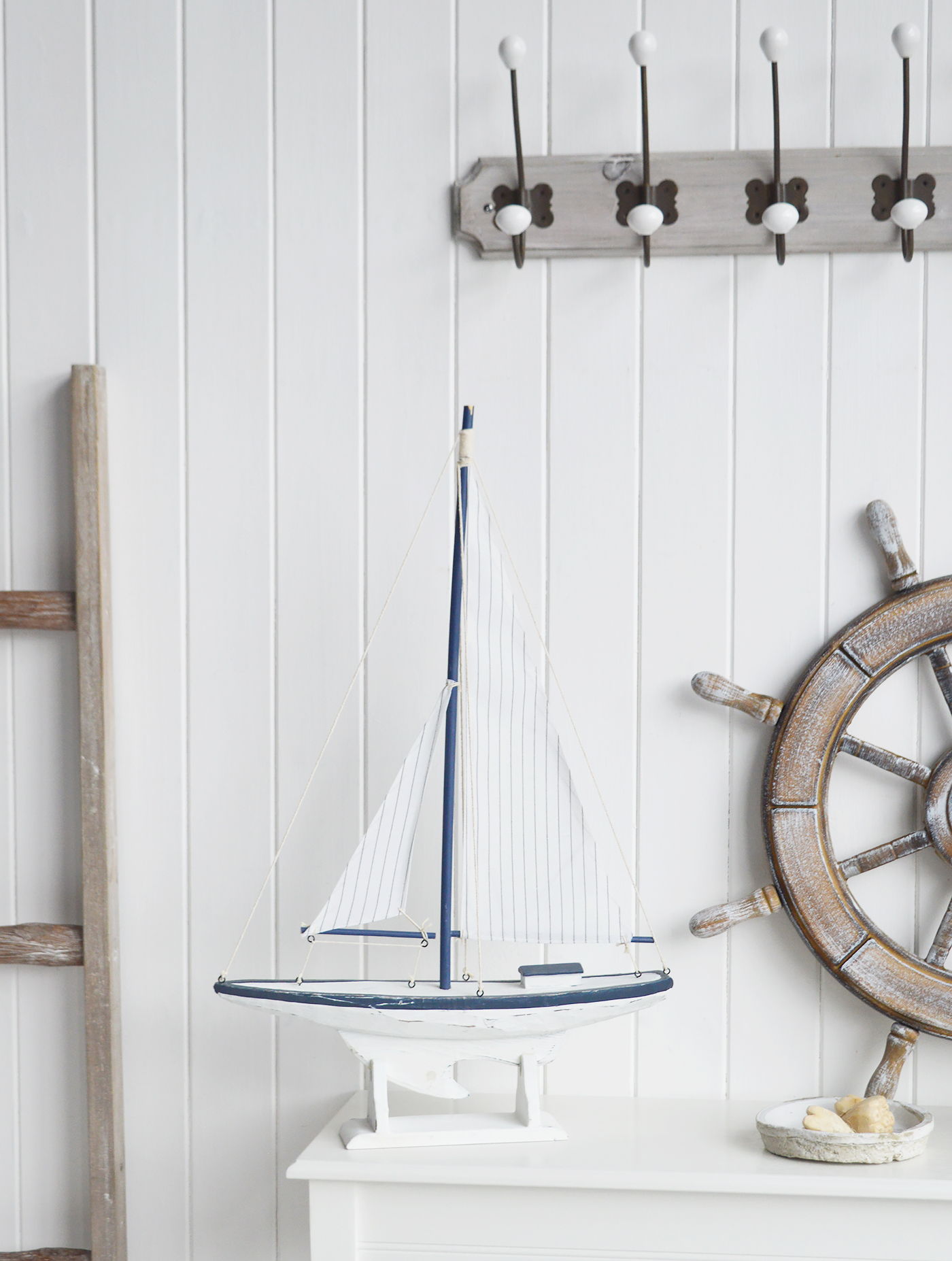 White Furniture and accessories for the home. A decorative white and blue yacht. Coastal Nautical Interior design Accessories for New England style homes and interiors