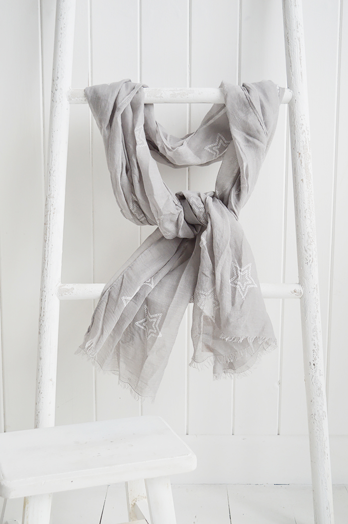 A grey scarf with white stars, from The White Lighthouse Furniture New England Lifestyle. 