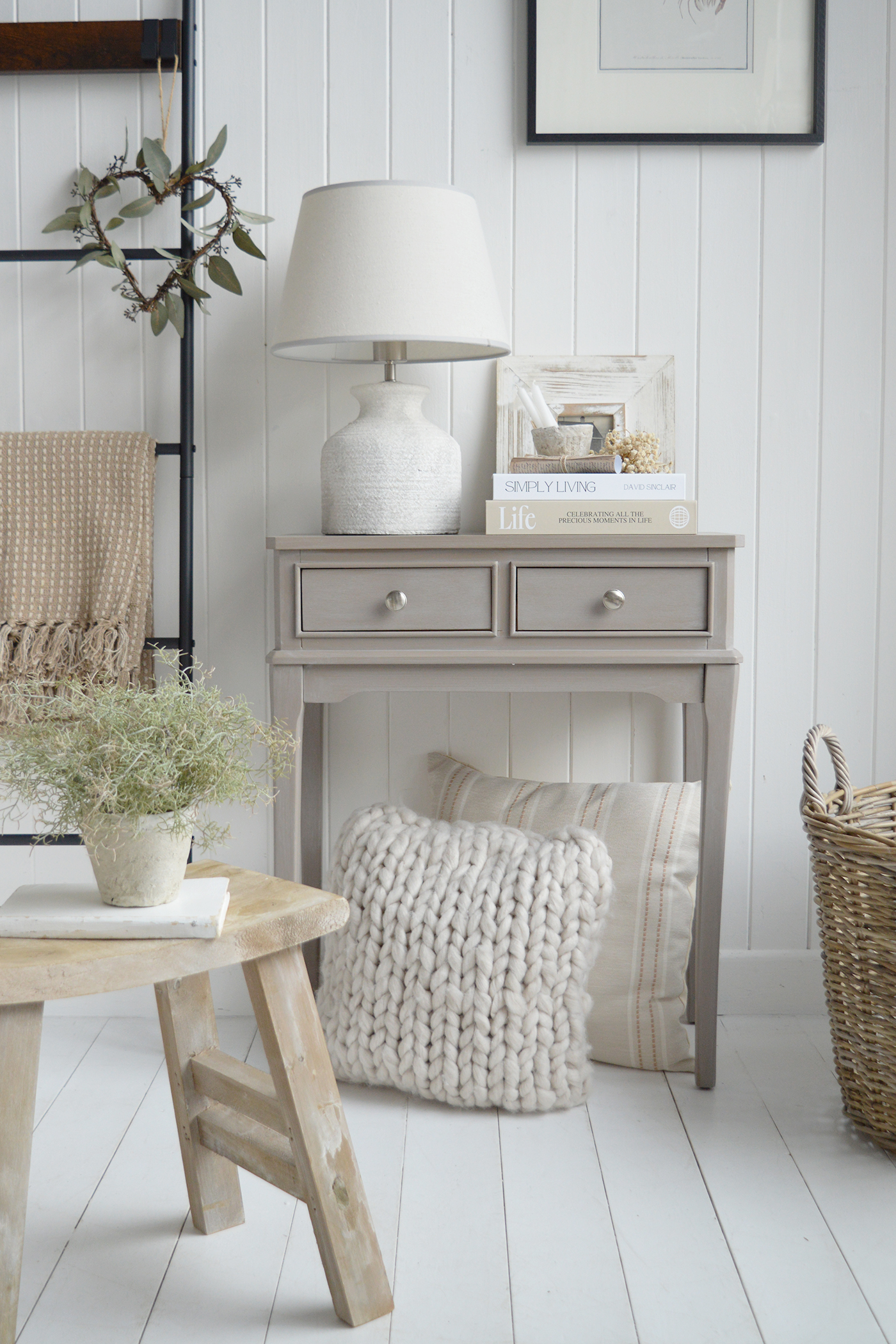 Woven baskets and natural wood stools add warmth to a coastal decor scheme.