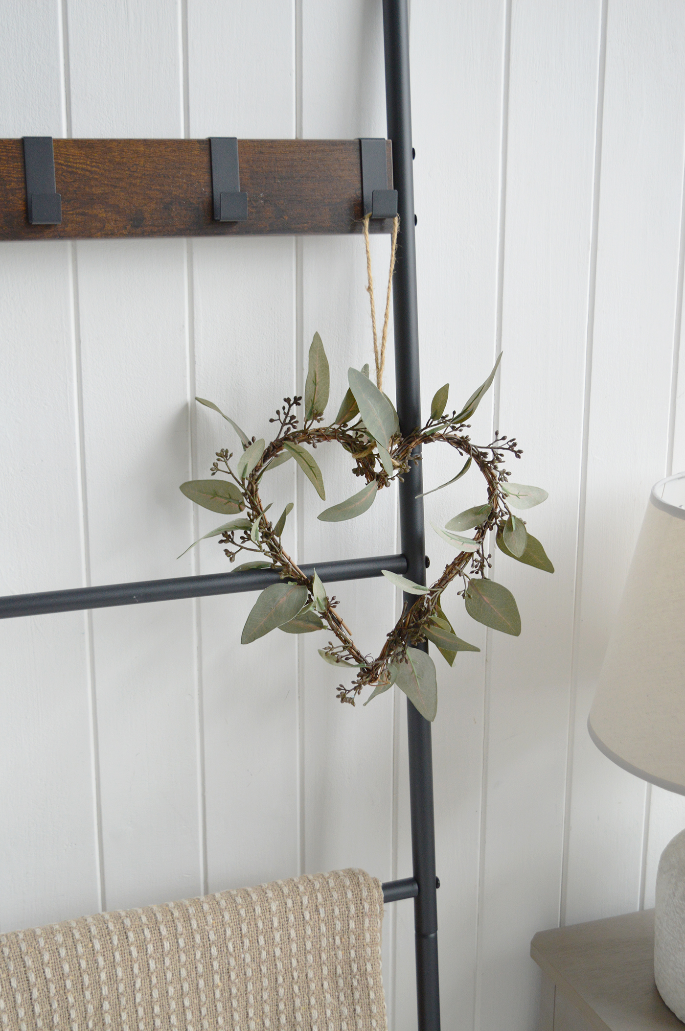 A slim console table styled with ceramics and books enhances a neutral interiors aesthetic.