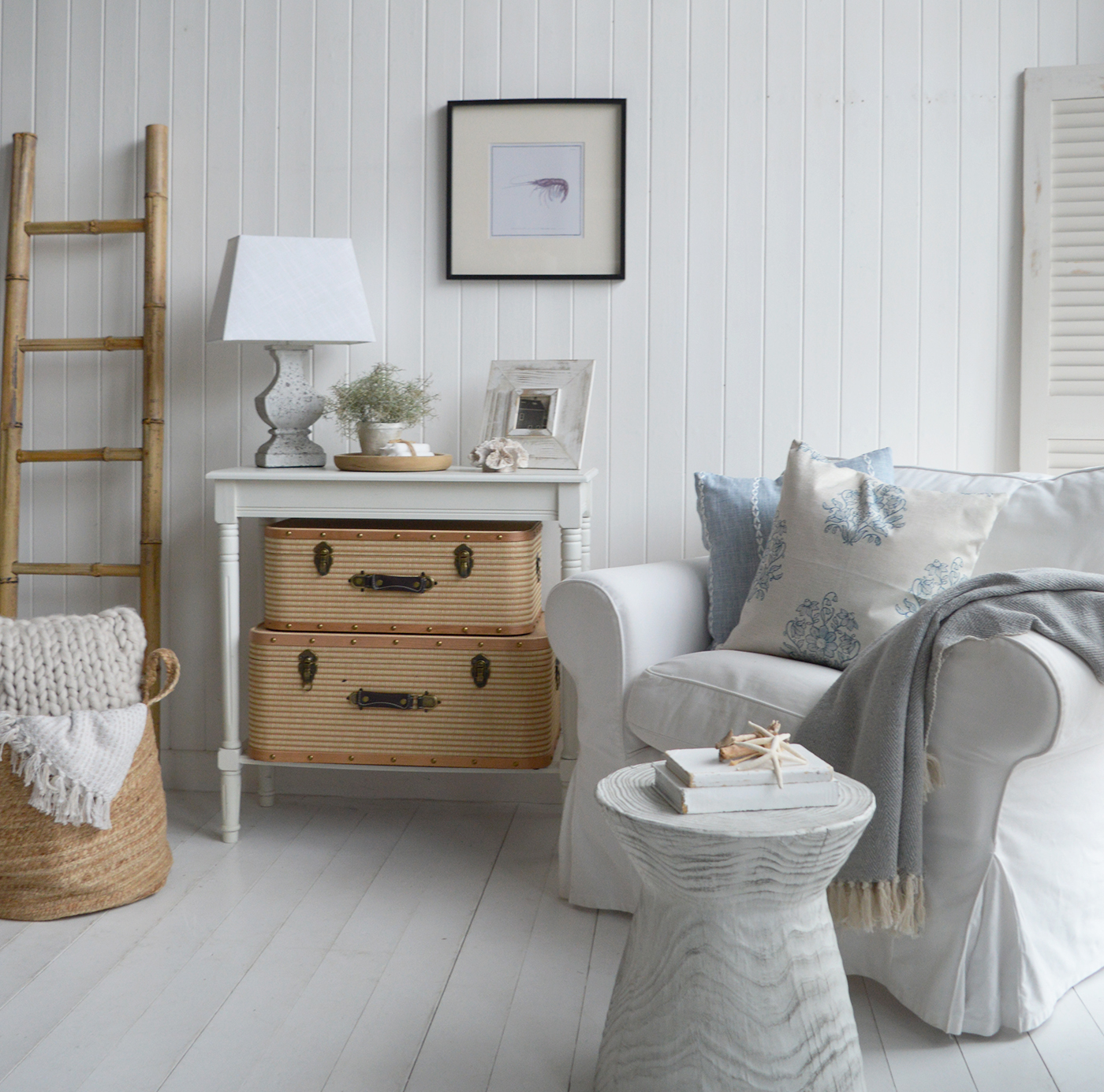 White slipcovered sofas, woven baskets, and rustic side tables are essential pieces in a coastal cottage home.