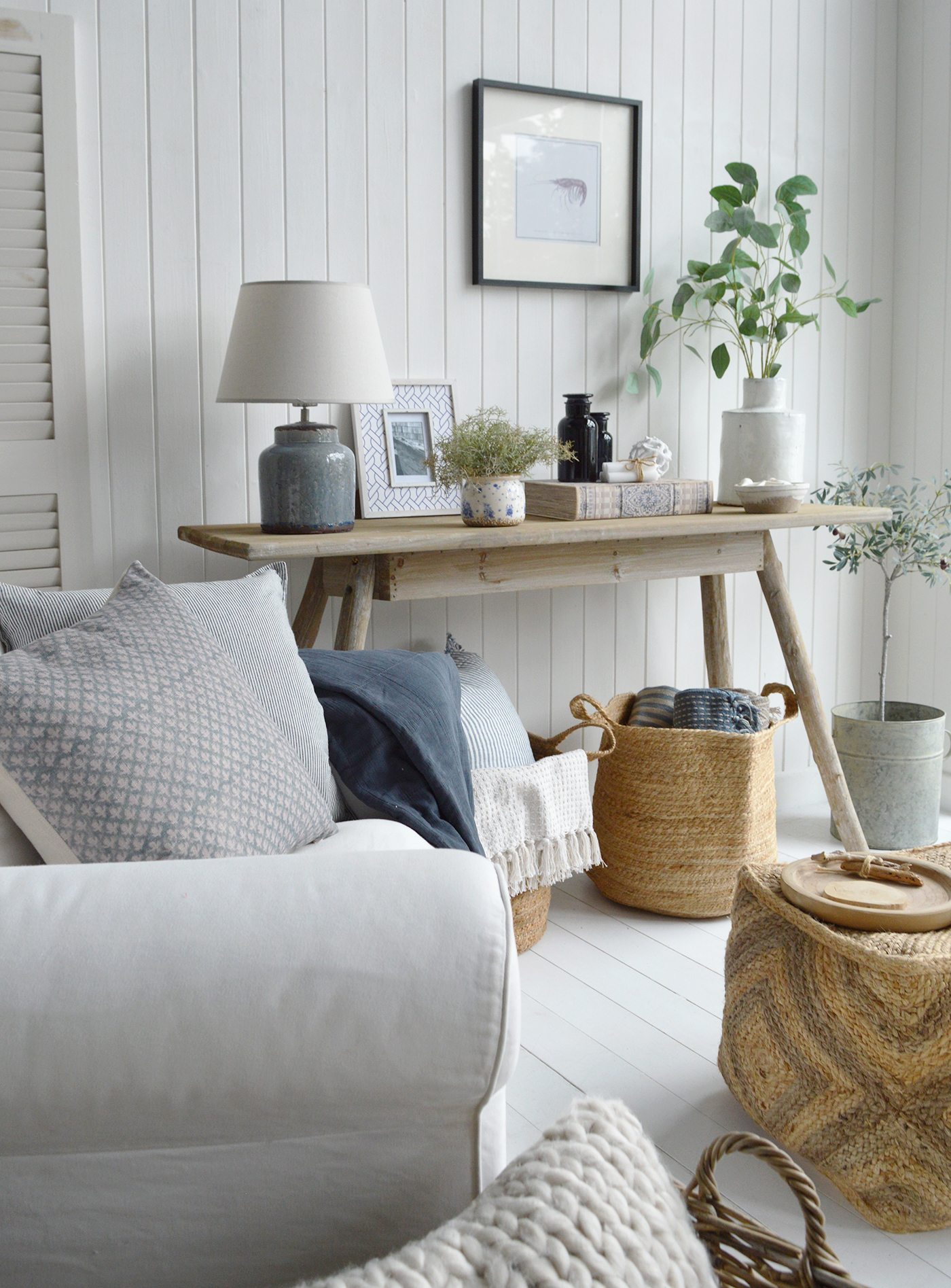 Modern beach house living room with airy white walls and coastal accents.