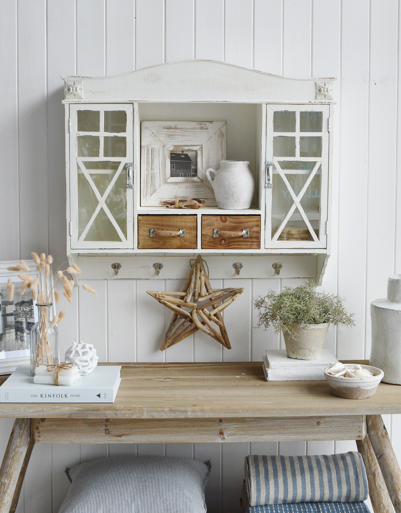 Modern country interiors with rustic console, driftwood star, and coastal chic Hamptons style accents.